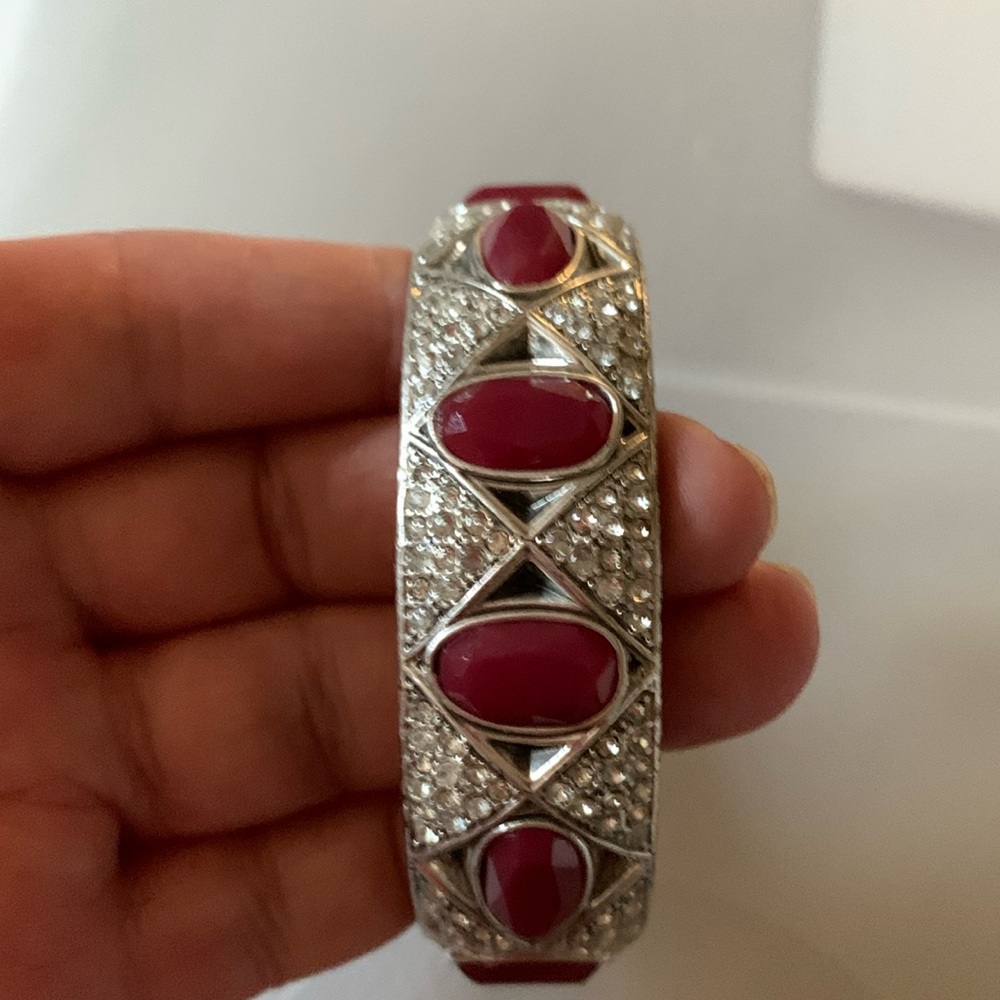 Bracelet with silver toned background   Diamond and gem stone design.